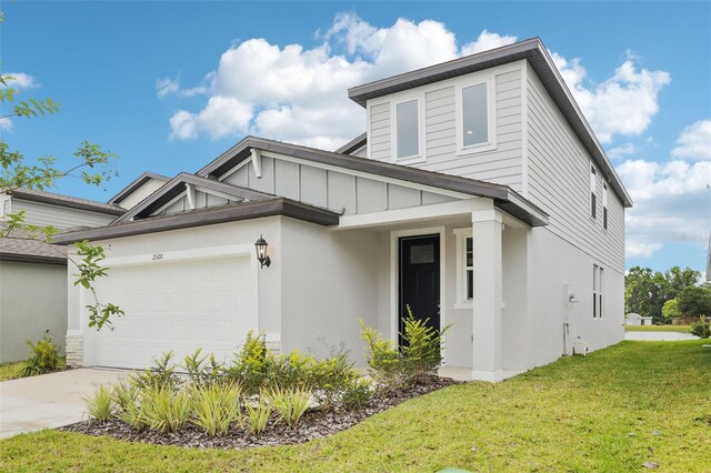 2320 E Newsome Rd, Plant City, FL 33565 - view of front of house with a garage, stucco siding, a front lawn, and concrete driveway