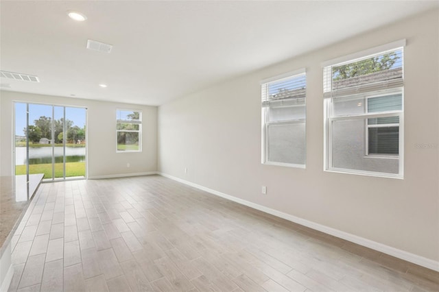 2320 E Newsome Rd, Plant City, FL 33565 - empty room with visible vents, wood finished floors, baseboards, and recessed lighting