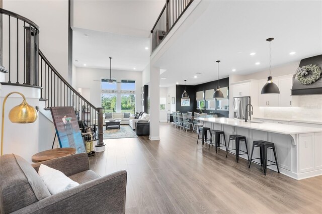 14749 Walcott Ave, Orlando, FL 32827 - living area with light wood-type flooring, a high ceiling, recessed lighting, and stairs