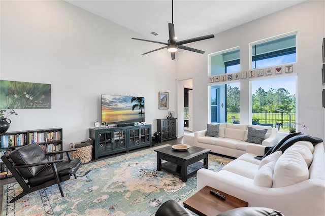 14749 Walcott Ave, Orlando, FL 32827 - living room with visible vents, a high ceiling, and ceiling fan