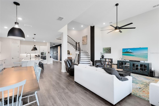 14749 Walcott Ave, Orlando, FL 32827 - living room featuring ceiling fan, recessed lighting, visible vents, and stairs