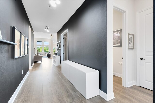 14749 Walcott Ave, Orlando, FL 32827 - hall featuring visible vents, light wood-style flooring, stairway, and baseboards