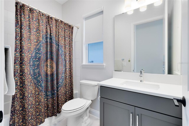 14749 Walcott Ave, Orlando, FL 32827 - full bathroom with toilet, shower / bath combo with shower curtain, vanity, and baseboards