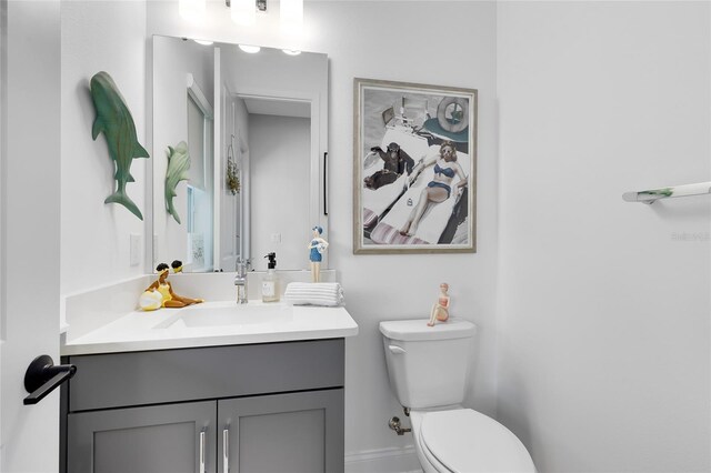 14749 Walcott Ave, Orlando, FL 32827 - bathroom featuring toilet, vanity, and baseboards