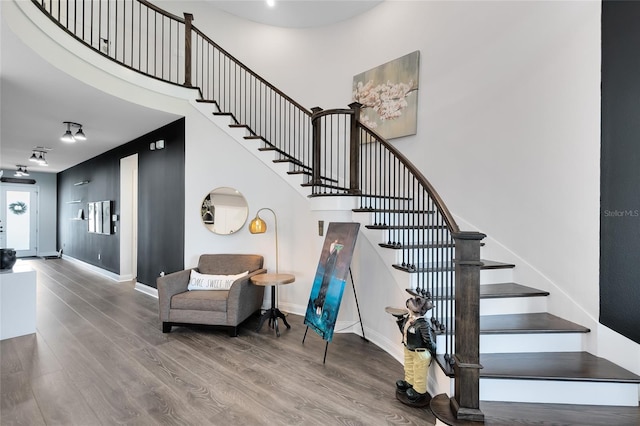 14749 Walcott Ave, Orlando, FL 32827 - stairs featuring wood finished floors, a high ceiling, and baseboards