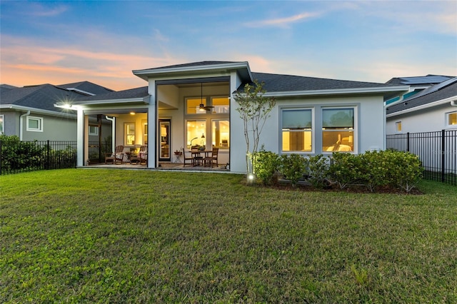14749 Walcott Ave, Orlando, FL 32827 - rear view of property featuring a yard, a patio area, fence, and stucco siding