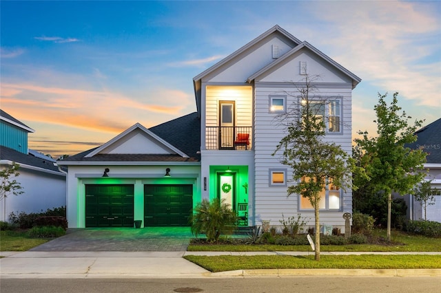 14749 Walcott Ave, Orlando, FL 32827 - view of front of house with driveway, a garage, and a balcony