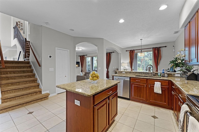 10033 Hart Branch Cir, Orlando, FL 32832 - kitchen featuring stainless steel appliances, a sink, light stone counters, a peninsula, and plenty of natural light