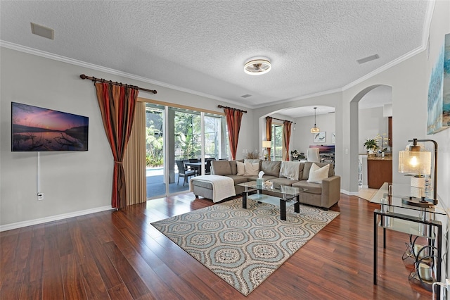 10033 Hart Branch Cir, Orlando, FL 32832 - living room featuring arched walkways, wood finished floors, a textured ceiling, crown molding, and baseboards