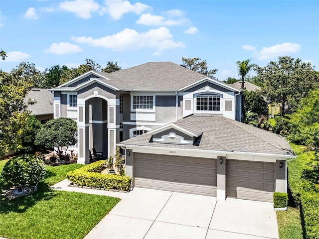 10033 Hart Branch Cir, Orlando, FL 32832 - view of front of house featuring stucco siding, concrete driveway, roof with shingles, and an attached garage