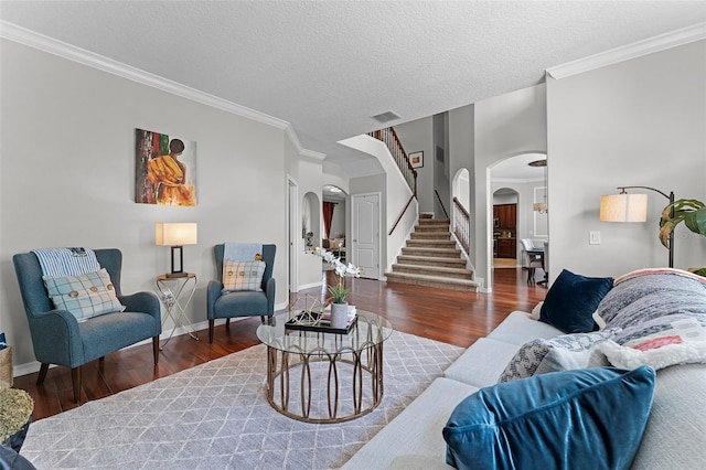 10033 Hart Branch Cir, Orlando, FL 32832 - living area featuring arched walkways, wood finished floors, crown molding, stairway, and baseboards
