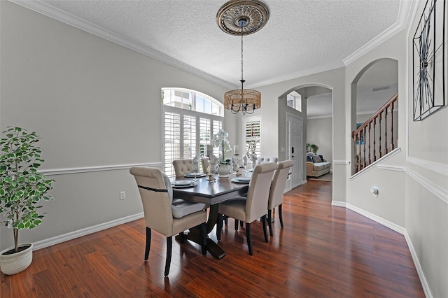 10033 Hart Branch Cir, Orlando, FL 32832 - dining space featuring a textured ceiling, wood finished floors, a chandelier, arched walkways, and stairway