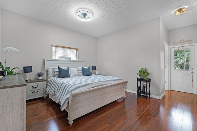 10033 Hart Branch Cir, Orlando, FL 32832 - bedroom with multiple windows, dark wood-style floors, a textured ceiling, and baseboards