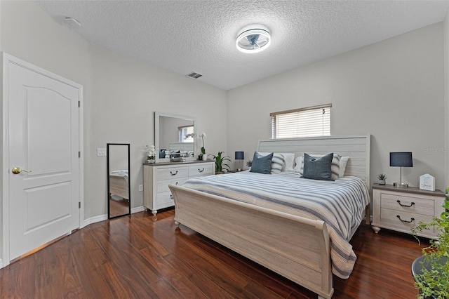 10033 Hart Branch Cir, Orlando, FL 32832 - bedroom with dark wood-style flooring, a textured ceiling, and baseboards