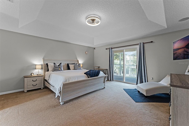 10033 Hart Branch Cir, Orlando, FL 32832 - bedroom with light colored carpet, a textured ceiling, access to outside, a raised ceiling, and baseboards