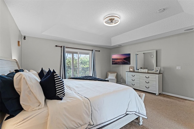 10033 Hart Branch Cir, Orlando, FL 32832 - bedroom featuring a raised ceiling, carpet floors, access to outside, a textured ceiling, and baseboards