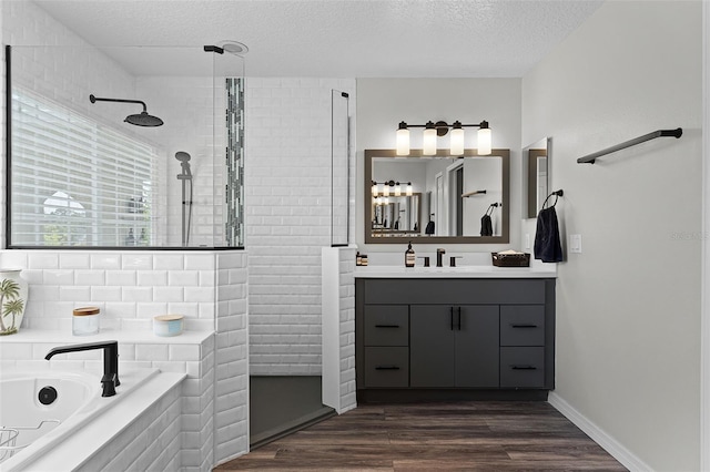 10033 Hart Branch Cir, Orlando, FL 32832 - full bath with tiled shower, a textured ceiling, a bath, vanity, and wood finished floors