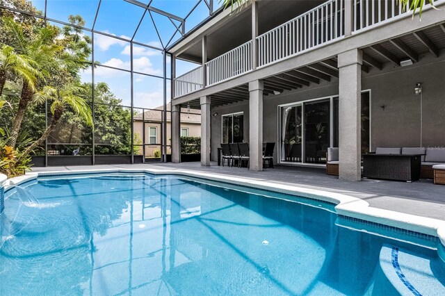 10033 Hart Branch Cir, Orlando, FL 32832 - swimming pool with a patio area, an outdoor hangout area, and glass enclosure