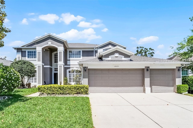 10033 Hart Branch Cir, Orlando, FL 32832 - traditional-style house featuring stucco siding, concrete driveway, a garage, and a front lawn