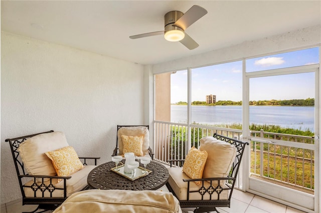 sunroom featuring a water view
