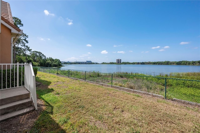 view of yard with a water view and fence
