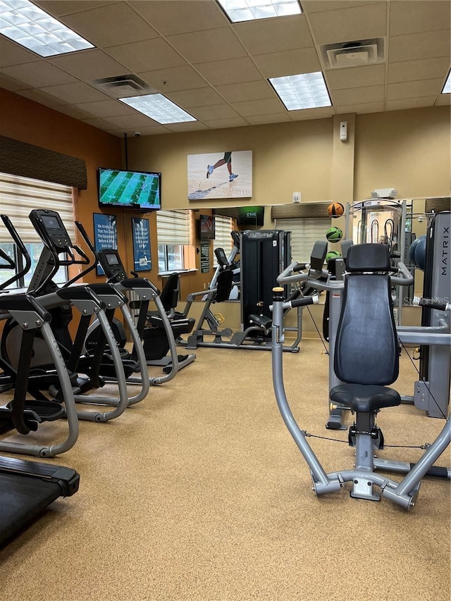 12539 Floridays Resort Dr Unit 208D, Orlando, FL 32821 - workout area with visible vents, a drop ceiling, and carpet floors