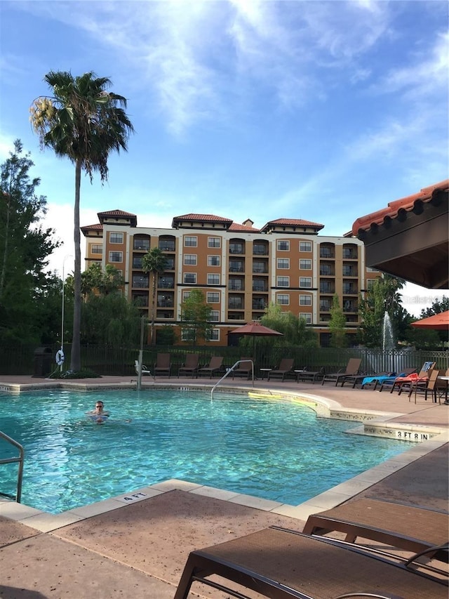 12539 Floridays Resort Dr Unit 208D, Orlando, FL 32821 - pool featuring a patio area and fence