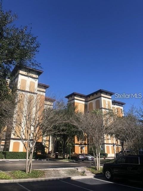 12539 Floridays Resort Dr Unit 208D, Orlando, FL 32821 - view of building exterior featuring uncovered parking