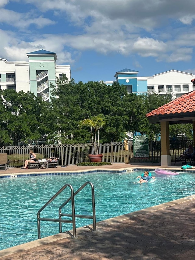 12539 Floridays Resort Dr Unit 208D, Orlando, FL 32821 - community pool featuring fence