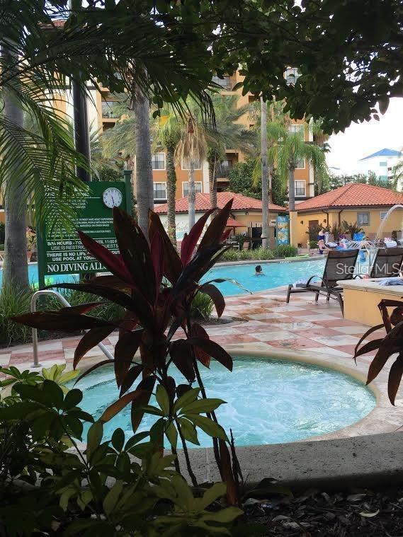 12539 Floridays Resort Dr Unit 208D, Orlando, FL 32821 - community pool featuring a patio