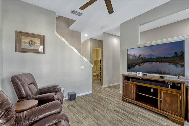 861 Taramundi Dr, Oviedo, FL 32765 - living room featuring light wood-type flooring, baseboards, visible vents, stairway, and ceiling fan