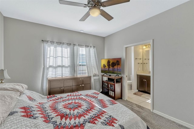 861 Taramundi Dr, Oviedo, FL 32765 - bedroom featuring a ceiling fan, a sink, connected bathroom, baseboards, and carpet flooring
