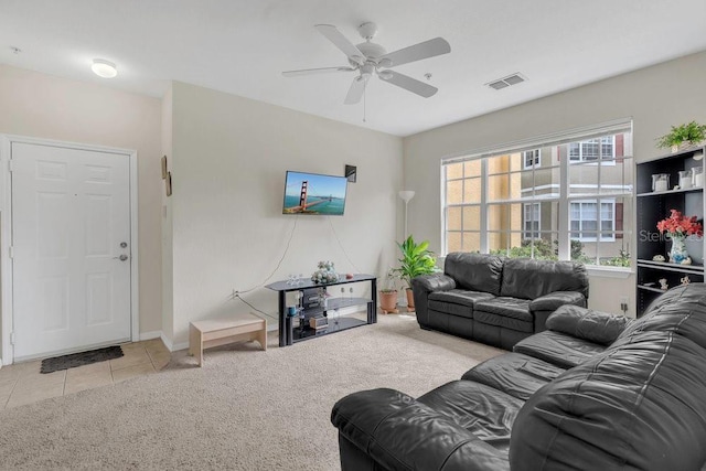 8213 Claire Ann Dr Unit 108, Orlando, FL 32825 - carpeted living area with tile patterned flooring, visible vents, and ceiling fan