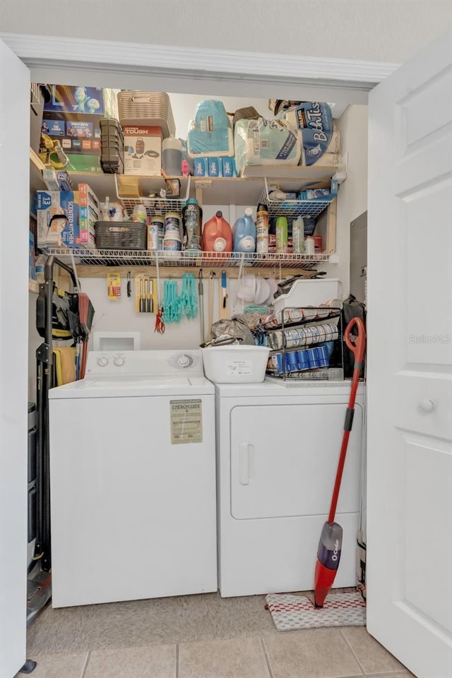 8213 Claire Ann Dr Unit 108, Orlando, FL 32825 - laundry area with washer and dryer, laundry area, and light tile patterned floors