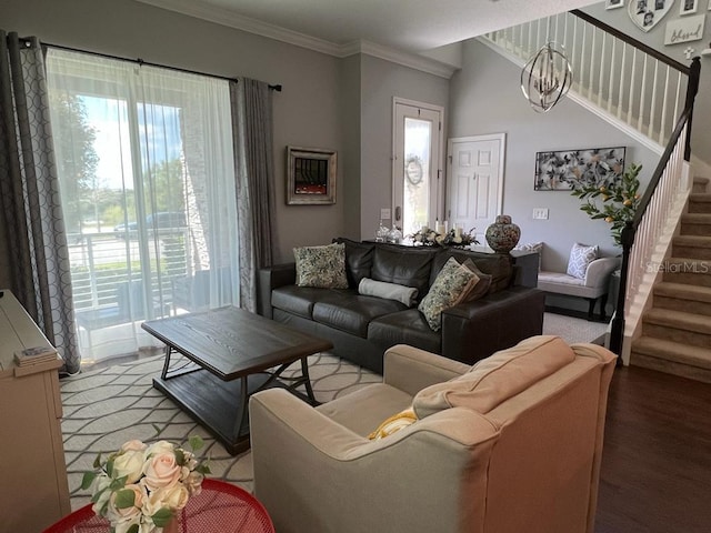 living area featuring crown molding, wood finished floors, and stairway
