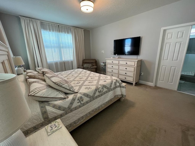 bedroom featuring light carpet, baseboards, and a textured ceiling