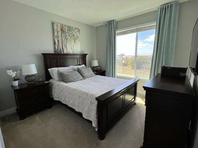 bedroom featuring baseboards and light carpet