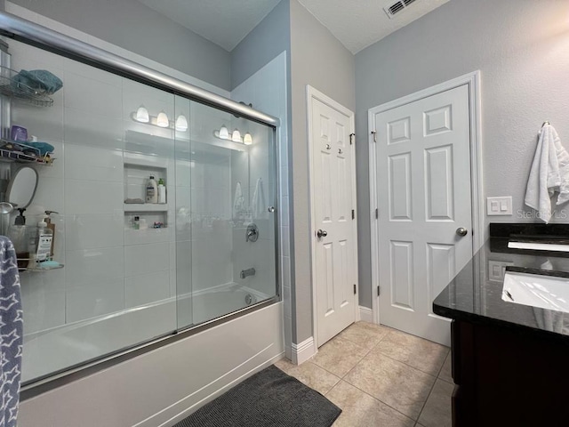 full bathroom with tile patterned flooring, vanity, and enclosed tub / shower combo