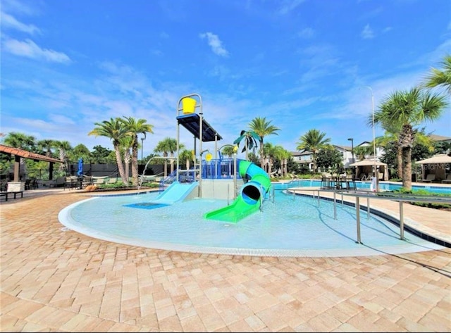 community playground featuring a water play area and a community pool