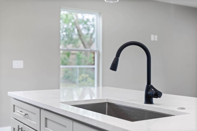 3 Orange Blossom Dr, Eustis, FL 32726 - interior details featuring white cabinets, light stone countertops, and a sink