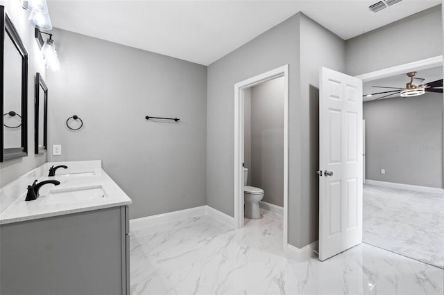 3 Orange Blossom Dr, Eustis, FL 32726 - bathroom featuring marble finish floor, toilet, a sink, and baseboards