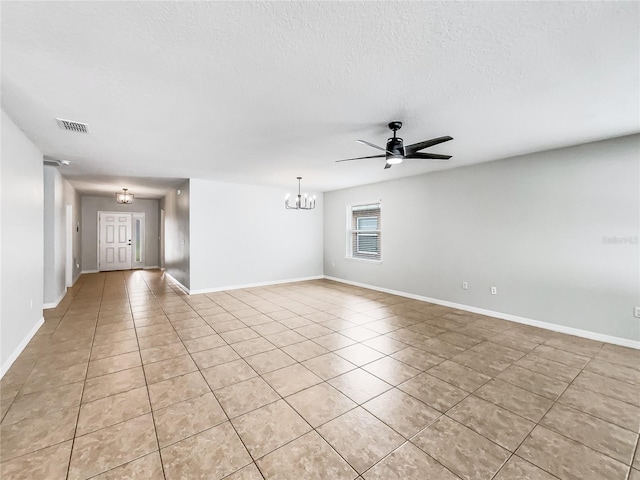 unfurnished room with baseboards, light tile patterned floors, a textured ceiling, visible vents, and ceiling fan with notable chandelier