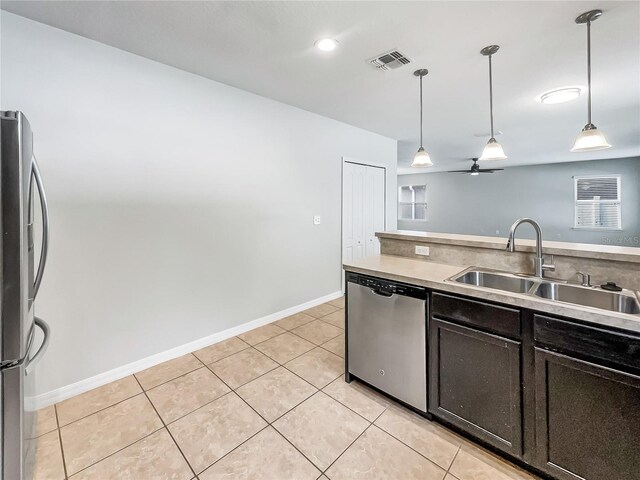 kitchen with pendant lighting, a sink, visible vents, and stainless steel appliances