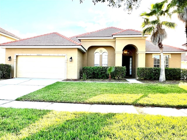 9046 Tuscan Valley Pl, Orlando, FL 32825 - mediterranean / spanish-style house with a tiled roof, a front yard, a garage, and stucco siding
