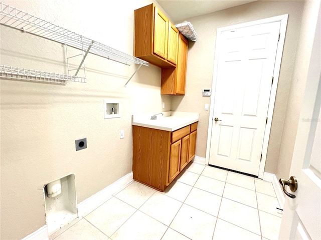 9046 Tuscan Valley Pl, Orlando, FL 32825 - laundry room featuring light tile patterned floors, hookup for a washing machine, electric dryer hookup, a sink, and baseboards