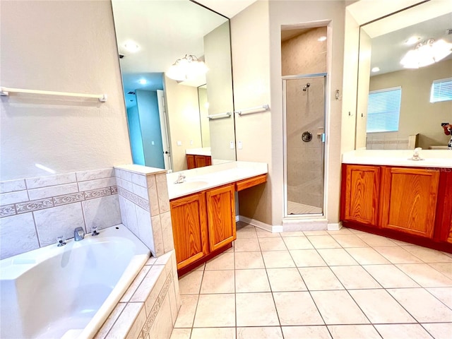9046 Tuscan Valley Pl, Orlando, FL 32825 - full bathroom featuring two vanities, a stall shower, tile patterned floors, a bath, and a sink