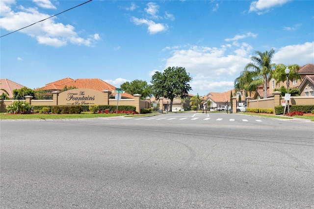 view of road with street lights, curbs, and a residential view