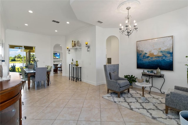sitting room with arched walkways, visible vents, and recessed lighting