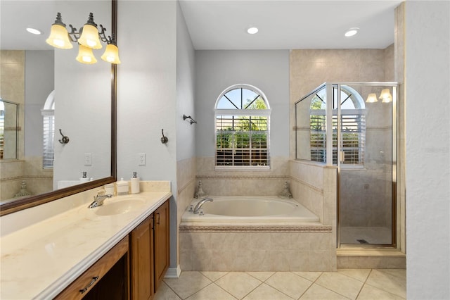 full bathroom with a shower stall, a bath, tile patterned flooring, and vanity