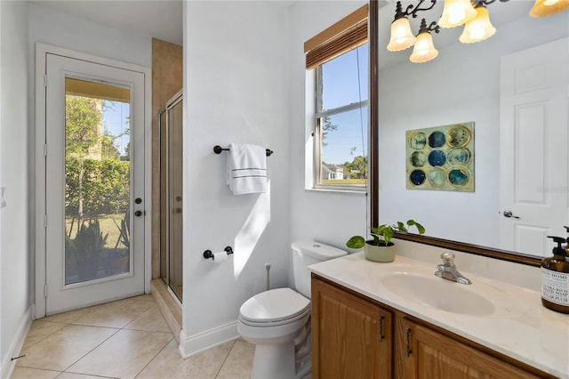 full bath featuring tile patterned floors, toilet, a stall shower, a chandelier, and vanity